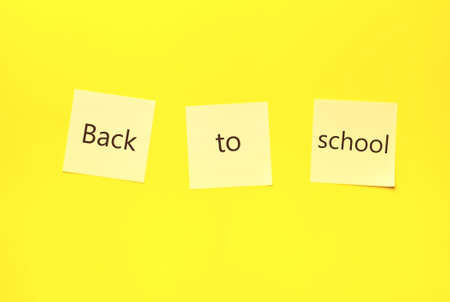 Back to school concept.   note pin stickers with text back to school on Yellow background.