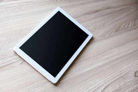 White tablet pc   on old wood backgroundの写真素材