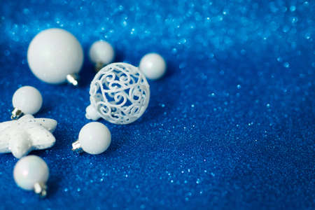 White Christmas balls and star, decoration on shiny blue backgroundの写真素材