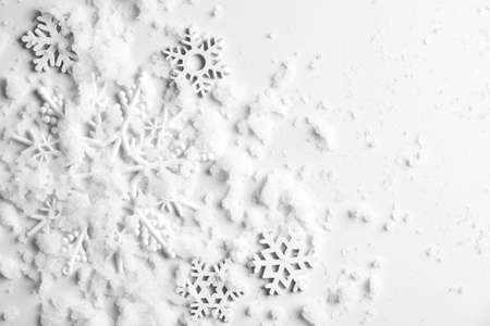 Christmas background with copy space made of snowflakes and snow on pastel gray background. Winter concept. Flat lay, top view, copy spaceの写真素材