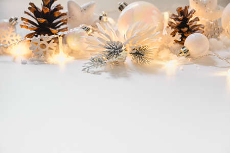 pearl and white color christmas and new year decoration on white background with lights border art. Christmas card with copy space for textの写真素材