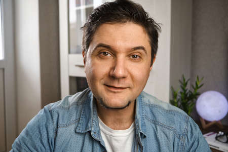 Middle aged man looking at camera making conference video call, e-coaching training online,...