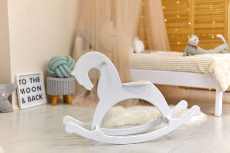 White wooden horse in Cute child's room interior with toys and modern furniture, bed with tentの写真素材