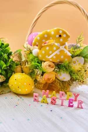 Colorful easter basket with eggs on a white wooden background, decorated with blossom spring....