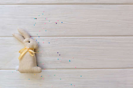 Easter bunny handmade gift diy idea. Minimal easter concept on white wooden background with copy spaceの写真素材