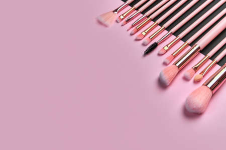 Set of professional brushes on a black and pink colored composed background top view point flat lay with copy space for textの写真素材
