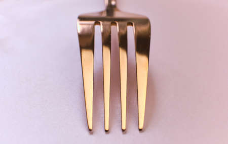 close up of rose metal fork on pink background with copy space. Selective focus