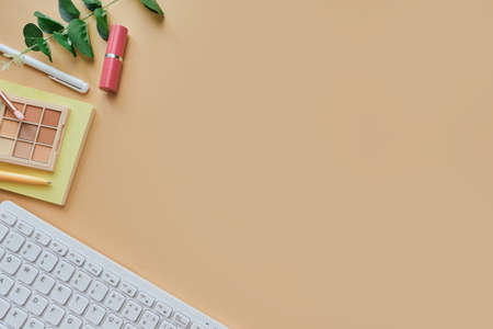 Flat lay, top view modern office table desk. Workspace with white keyboard, pens, notebook, beauty...