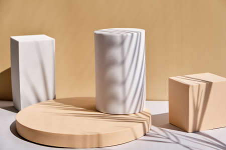 Scene with geometrical forms white and beige background with palm shadows. Geometrical podium,...