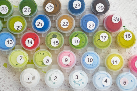 Numbered containers with paints lie on the canvas background. Creative leisure activitiesの写真素材