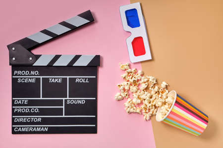 Flat lay composition with popcorn, 3d glasses and clapper board, space for text on color background....
