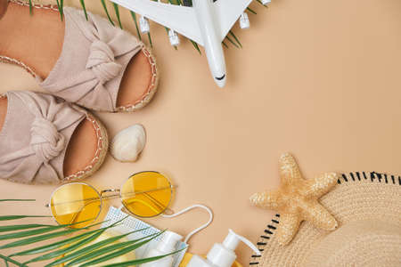 sun protection cream, sunglasses, seashell and starfish, summer shoes and surgical mask and airplane...