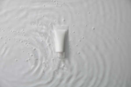 beauty spa medical skincare and cosmetic bottle cream packaging product on water pool white decor background with summer season sun light. Medicine serum for anti-aging collagen facial, cleansingの写真素材