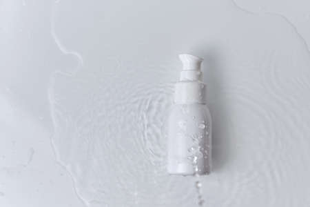 beauty spa medical skincare and cosmetic. lotion dispenser bottle mock up cream packaging product on white water background with drops, summer fresh concept.の写真素材
