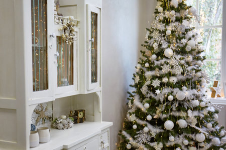 Bright living room decorated for the new year and christmas with decor and lights, a beautiful treeの写真素材