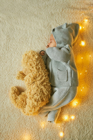 My Best Friend. Newborn baby sleeping with her teddy bear. New family and baby protection concept. Top veiwの写真素材