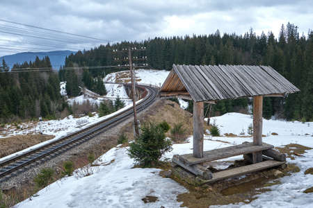 Mountain snow railway, viaduct and old wooden station against the background of forest and mountains. Winter, Ukrainian Carpathiansの写真素材