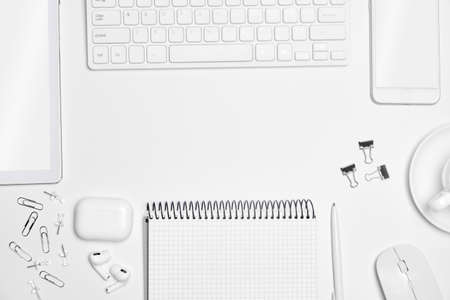 Top view office desk workspace with tablet and smartphone  on white table background with text space...
