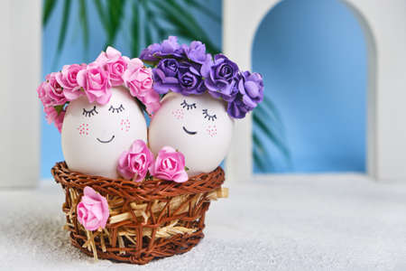 Easter DIY do it yourself. Minimal easter holiday concept. Easter eggs with painted smiley faces on a blue background with arches. Easter travel and vacation concept. Married.の写真素材