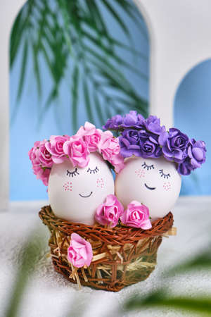 Easter DIY do it yourself. Minimal easter holiday concept. Easter eggs with painted smiley faces on a blue background with arches. Easter travel and vacation concept. Married.の写真素材