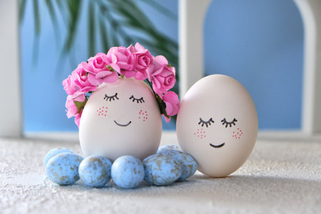 Easter DIY do it yourself. easter holiday concept. Easter eggs with painted smiley faces on a blue background with arches. Easter travel and vacation concept. Married, wedding, coupleの写真素材