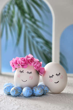 Easter DIY do it yourself. easter holiday concept. Easter eggs with painted smiley faces on a blue background with arches. Easter travel and vacation concept. Married, wedding, coupleの写真素材
