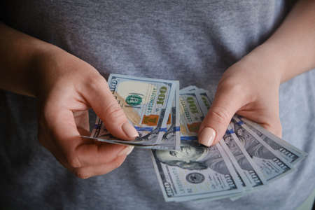 Close-up of female hands counting money dollar banknotes, Dollar currency. The concept of currency...