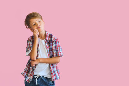 Young happy teen boy with in casuals on pink background.の写真素材