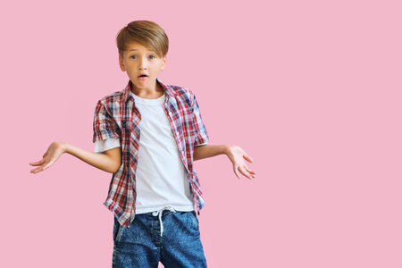 Young happy teen boy with in casuals on pink background.の写真素材