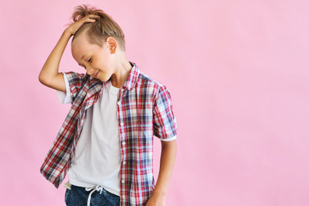 Young happy teen boy with in casuals on pink background.の写真素材