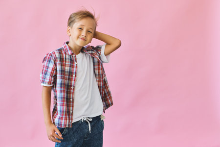 Young happy teen boy with in casuals on pink background.の写真素材
