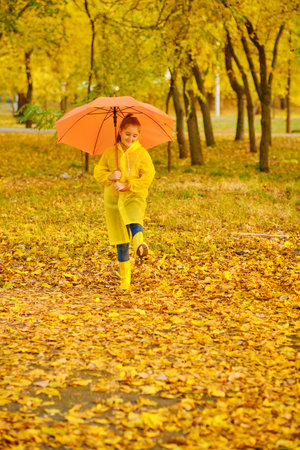 happy kid in autumn parkの写真素材