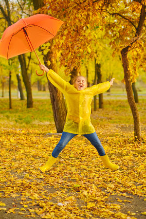 happy kid in autumn parkの写真素材