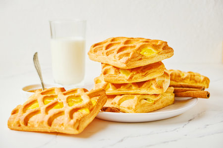 Tasty breakfast with stack of puff pastry mini pies with pear and lime jamの写真素材