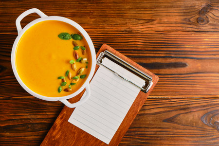 Homemade pumpkin soup with cream in a white bouillon dishの写真素材
