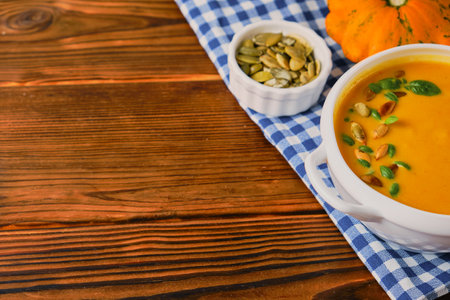 Homemade pumpkin soup with cream, pumpkin seeds and basilの写真素材