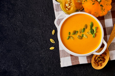 Pumpkin cream soup with pumpkin seeds servedの写真素材
