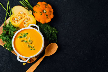 Pumpkin cream soup with pumpkin seeds servedの写真素材