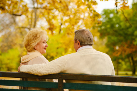 Active seniors on a walk in autumn forestの写真素材