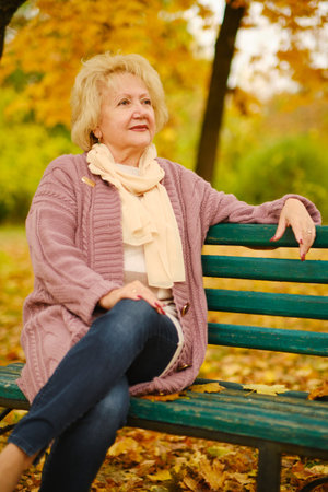 portrait of happy grandmother on a park benchの写真素材