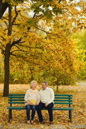 Active seniors on a walk in autumn forestの写真素材
