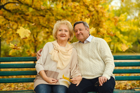 Active seniors on a walk in autumn forestの写真素材