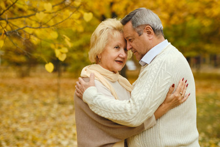 Active seniors on a walk in autumn forestの写真素材