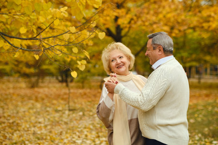 Active seniors on a walk in autumn forestの写真素材