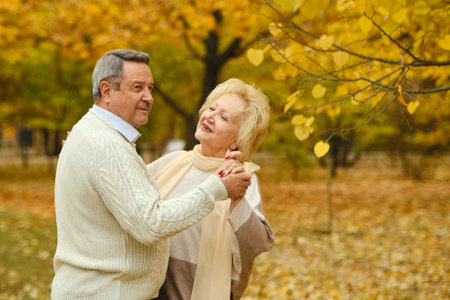 Active seniors on a walk in autumn forestの写真素材