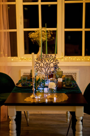 Romantic dinner table setting with festive lights