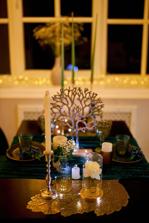 Romantic dinner table setting with festive lightsの写真素材