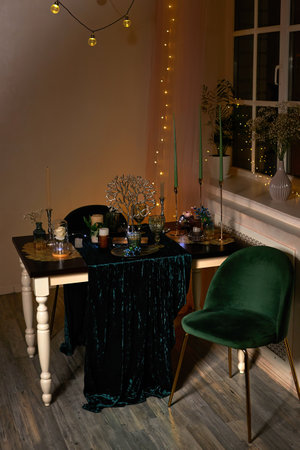 Romantic dinner table setting with festive lightsの写真素材