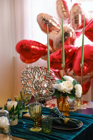 Festive table setting in dining room decorated for Valentines Dayの写真素材