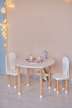 Stylish child table and chair. White and wooden colors.の写真素材